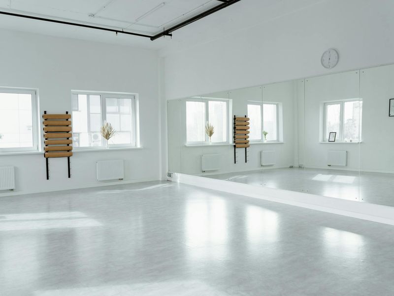 Bright and empty fitness studio with wooden flooring